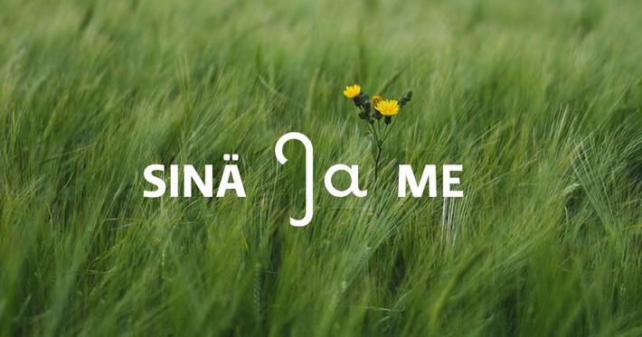 Kuvassa niitty ja siinä sanat sinä ja me.